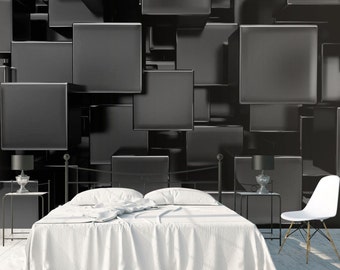 May include: A white bed with a white duvet cover and two white pillows sits in front of a wall covered in black 3D geometric shapes.