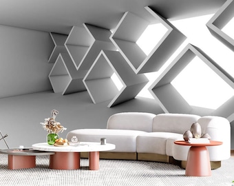 May include: A white sectional sofa with a white, geometric patterned wall behind it. The sofa is in a living room setting with two round, red coffee tables and a vase of flowers on one of the tables.