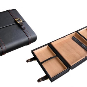 May include: Black leather case with red stitching and gold-colored buckles. The case is shown closed and open, revealing a light brown interior with compartments and a black accessory. A stylish storage solution.