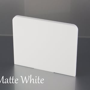 May include: A close-up of a white, rectangular, matte acrylic sheet. The sheet is smooth and has a slightly rounded edge. The text "Matte White" is printed below the sheet.