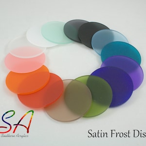 May include: A selection of satin frost acrylic discs in various colours arranged in a circle. The colours include white, light blue, teal, purple, green, brown, orange, pink, and grey. The discs are labelled "Satin Frost Discs".