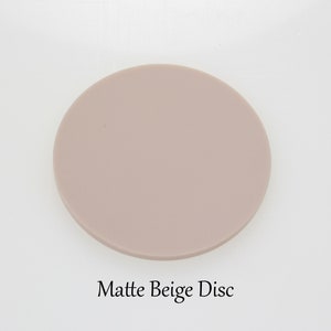 May include: A matte beige disc. This is a blank disc that can be used for crafts or other projects.