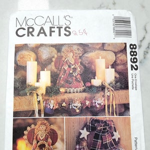 May include: McCall's Crafts pattern 8892 for a Christmas angel and wreath. The pattern includes instructions for making a plaid angel with a lace trim and a plaid wreath with a bow and stars.