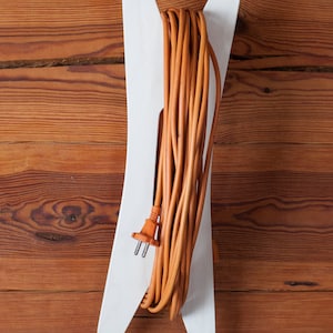 Extension Cord Holder. Unique design. Portable. With handle. Plywood. Stylish. White.