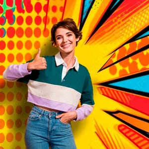May include: A woman with short brown hair is wearing a green, white and purple striped collared shirt. She is wearing blue jeans and has her hand in her pocket. She is smiling and giving a thumbs up. The background is a yellow, orange, red and blue comic book style pattern.