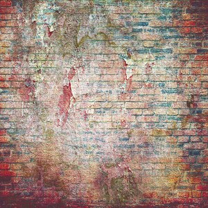 May include: A weathered brick wall with red, blue and yellow paint peeling off. The wall has a distressed, vintage look.