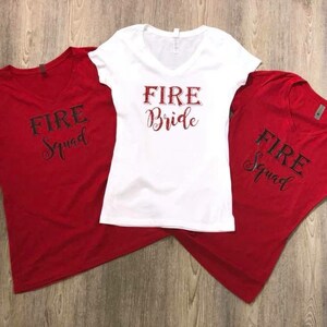 May include: Three white t-shirts with red text. One shirt says "Fire Bride" and the other two say "Fire Squad".
