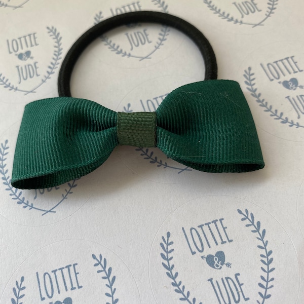 One dark green school bow on a hair tie elastic school uniform match bow. Hunter green