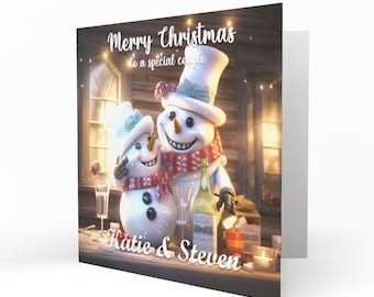 May include: A Christmas card depicting two snowmen, one in a top hat and the other in a smaller hat, both with red scarves. The card says "Merry Christmas to a special couple" with the names "Katie & Steven".