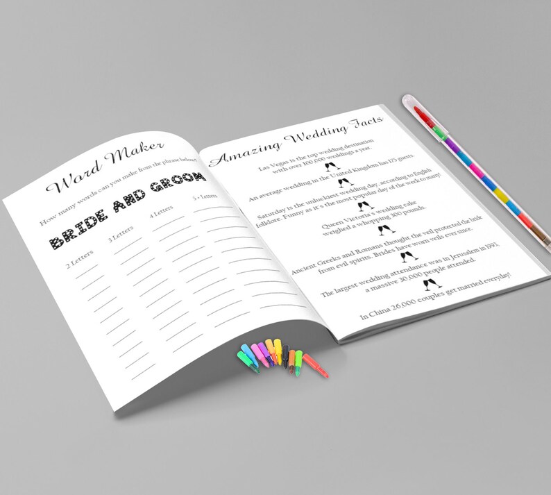 May include: A white open book with the text "Ward Maker" and "Amazing Wedding Facts". The book has lined pages and is accompanied by a colorful pen and a set of small, colorful markers. The text includes wedding-related facts.