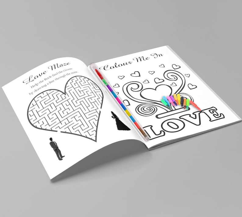 May include: Open wedding activity book with a heart-shaped maze and coloring pages. The text on the left page reads "Love Maze" and the right page says "Colour Me In LOVE". A set of colorful markers is included.