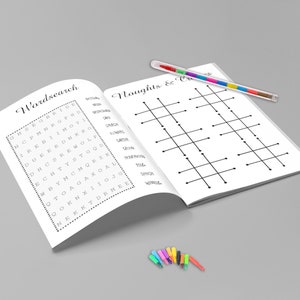 May include: An open book with two pages featuring a word search and a tic-tac-toe game. A multi-colored pen rests on the right page. Several small, colorful markers are at the bottom.