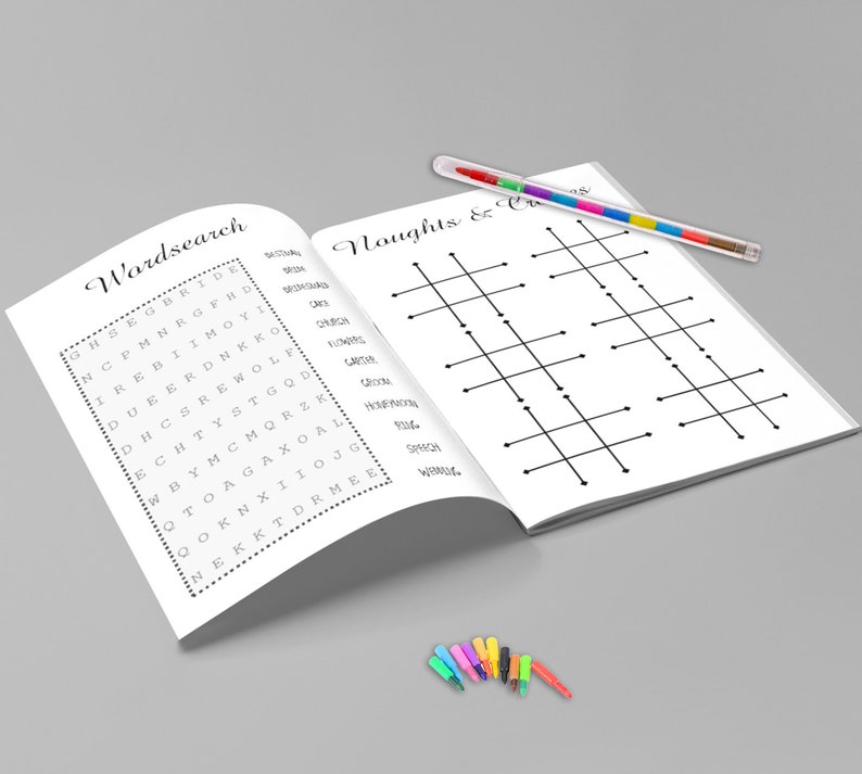 May include: An open book with two pages featuring a word search and a tic-tac-toe game. A multi-colored pen rests on the right page. Several small, colorful markers are at the bottom.