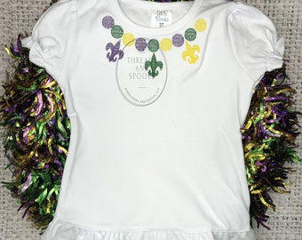 Girls Ruffle Sleeve and Hem shirt with Mardi Gras beads and Fleur de lis embroidered around neckline