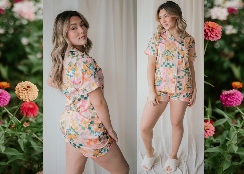 May include: A pink and green floral print pyjama set with a short-sleeved top and shorts. The top has a button-up front and a collar.