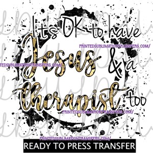May include: A ready-to-press transfer with the text "It's OK to have Jesus & a therapist too" in black and gold leopard print, surrounded by a black and white splatter design. The text is centered on a white background.