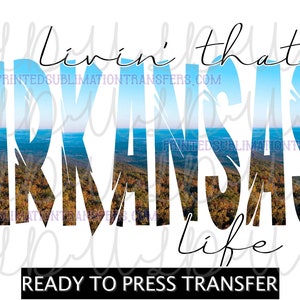 May include: White background with the words "Livin' that Arkansas Life" in black script. The word "Arkansas" is filled with a landscape image of a forest and sky. The text "READY TO PRESS TRANSFER" is at the bottom.