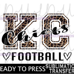 May include: A sublimation transfer design featuring the text "KC Chiefs" in black script over a leopard print design. The word "FOOTBALL" is below, with hearts on either side. The words "READY TO PRESS" and "SUBLIMATION TRANSFER" are at the bottom.