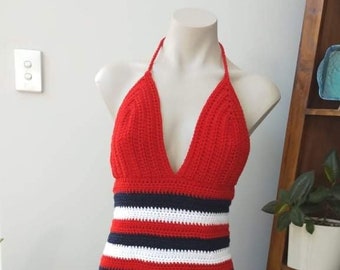 May include: A red, white, and blue striped crochet halter top. The top has a deep V-neckline and is made with a thick yarn.