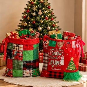 May include: Two Christmas gift sacks filled with presents. One sack is patchwork with Santa Claus images, green squares, and red plaid. The other is red with a snowman, Christmas tree, and the words "SNOW Much FUN".