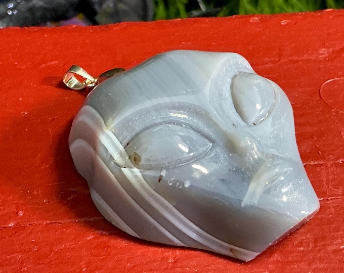 Hand-Carved Chalcedony Alien Skull Pendant: White & Blue Crystal