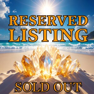 May include: A cluster of translucent, golden-yellow crystals sits on a sandy beach under a bright sun. The text RESERVED LISTING appears in large orange letters at the top, and the text SOLD OUT appears in orange letters at the bottom.