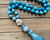 Smiling buddha hand knotted gemstone mala