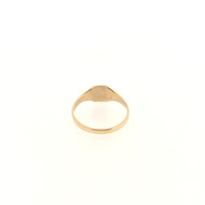 May include: A gold signet ring with a smooth, oval-shaped top.