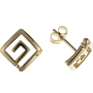 May include: A pair of gold-toned earrings with a square design featuring a Greek key pattern.