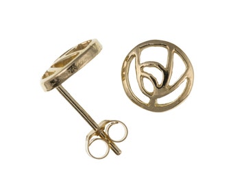 May include: A pair of gold-toned stud earrings with a circular design featuring an intricate, abstract pattern.