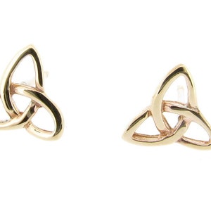 May include: A pair of gold-toned Celtic knot earrings. The earrings are in the shape of a trinity knot, a traditional Celtic symbol.