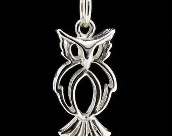 May include: A silver owl pendant necklace with a detailed design. The owl is facing forward with its wings spread out. The necklace is on a silver chain.