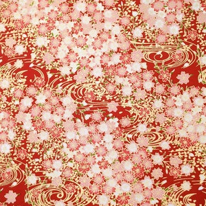 May include: Red fabric with a repeating pattern of white and pink cherry blossoms and gold swirling waves.