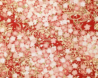 May include: Red fabric with a repeating pattern of white and pink cherry blossoms and gold swirling waves.