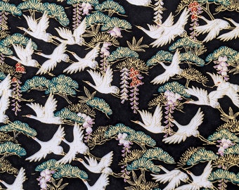 May include: A black background with a repeating pattern of white cranes flying amongst gold and green stylised pine trees and purple wisteria flowers.