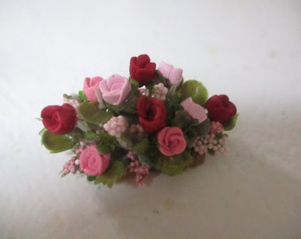 Miniature 2"w by 1"h Centerpiece of mauve/burgundy and pink roses with berry accents