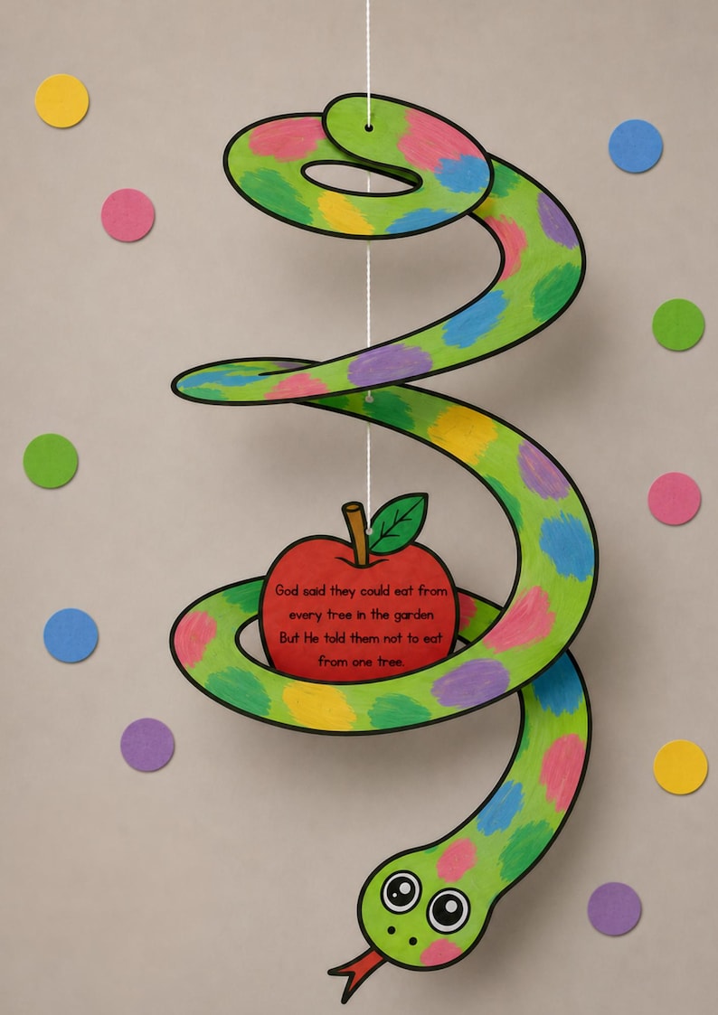 May include: A whimsical, handmade papercraft snake with a green body, colorful polka dots, and a red apple. The apple has text that reads "God said they could eat from every tree in the garden But He told them not to eat from one tree."