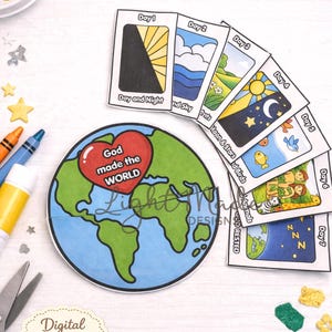 Op de afbeelding: Een kleurrijke knutselset met de tekst "Printable Creation pocket Craft". De set bevat geïllustreerde kaarten die de dagen van de schepping uitbeelden, een papieren wereldbol en knutselbenodigdheden.