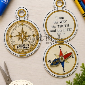 May include: A printable paper compass craft featuring gold and white circular designs. One compass displays the text 'JESUS IS THE WAY' and the other shows 'I am the WAY the TRUTH and the LIFE John 14:6' with a rotating needle labelled 'JESUS'.