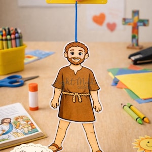 Puede incluir: Una manualidad imprimible con una figura de dibujos animados de un hombre con una túnica marrón, suspendida por un hilo azul de un palo amarillo. La imagen incluye el texto "Printable Lame Man Walks Craft" y "Digital Download". Se ven otros materiales de manualidades.