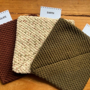 May include: Three knitted squares in different colors: brown, beige with green flecks, and olive green. The squares are labeled "Chocolate", "Earth", and "Olive" respectively.