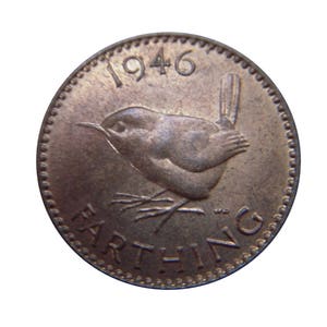 May include: A 1946 British farthing coin made of copper. The coin features a wren bird design and the word "FARTHING" inscribed around the edge.