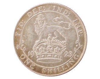 May include: Silver coin with the inscription "FID. DEF. IND: IMP." and "ONE SHILLING" around a lion and crown. The date "1923" is visible.