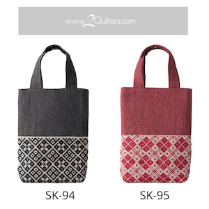 May include: Two tote bags with a geometric pattern on the bottom half. The bag on the left is gray with a black and white pattern. The bag on the right is red with a red and white pattern. The text "www.2quilters.com" is at the top of the image. The bags are labeled "SK-94" and "SK-95".