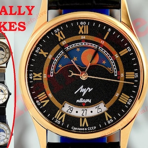 May include: A gold-tone wristwatch with a black dial featuring Roman numerals, a moon phase display, and a date window. The text TOTALLY FAKES is printed in red on the left. The dial includes the Cyrillic text Luch and Kvartc, with Sdelano v SSSR.