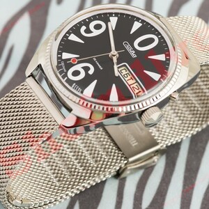 May include: A silver wristwatch with a black face and large white numerals. The watch has a mesh strap and a date display. The watch face has red accents and the text "Сделано в СССР".
