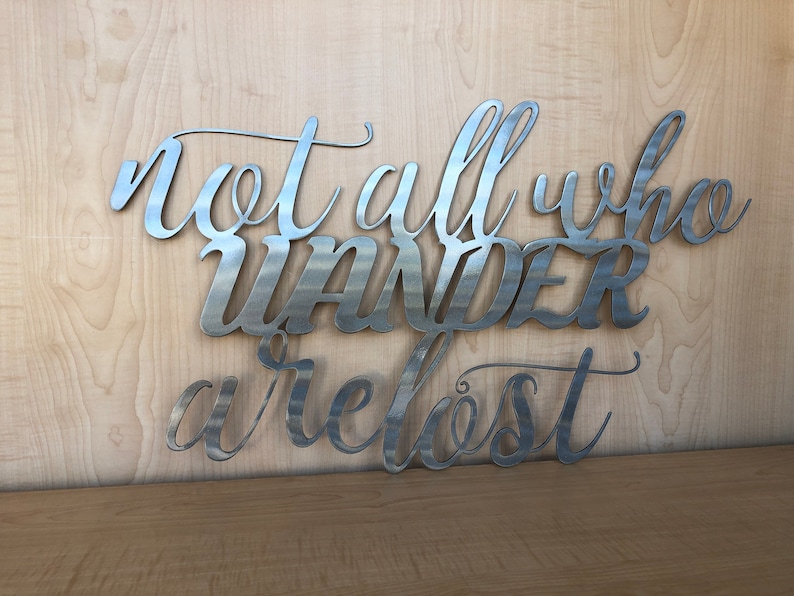 May include: Metal wall art with the quote "Not all who wander are lost".