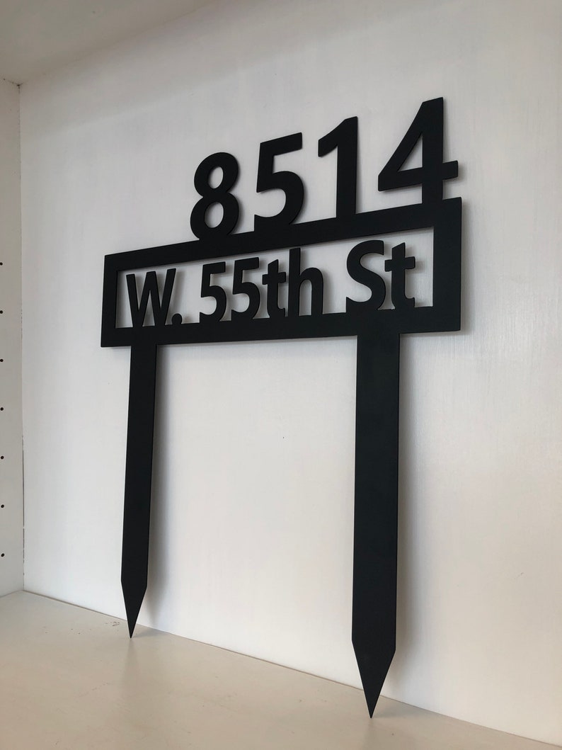 May include: Black metal yard sign with the address "8514 W. 55th St" and two stakes.