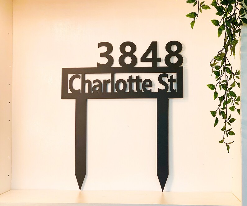 May include: Black metal yard sign with the address 3848 Charlotte St.