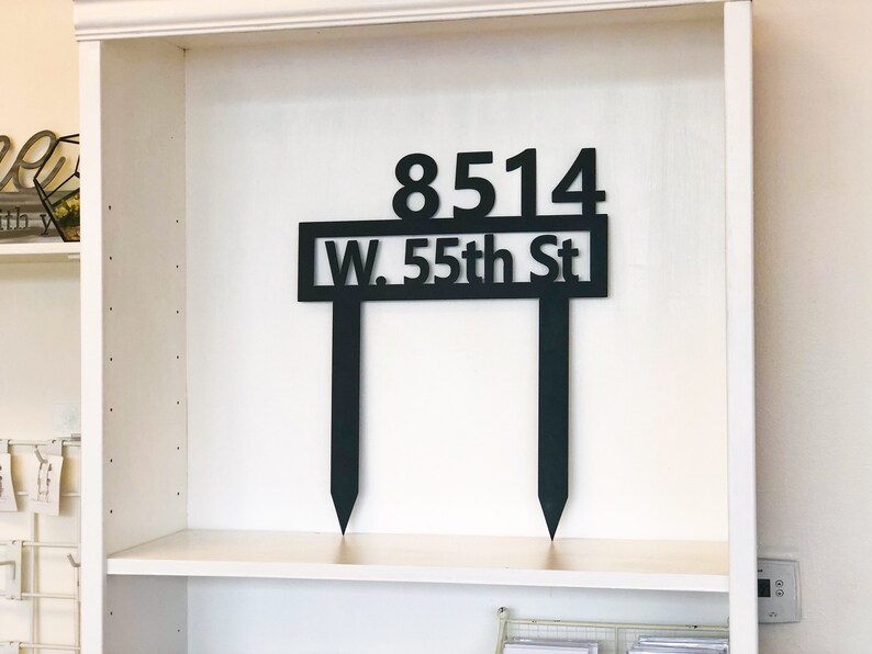 May include: Black metal house number sign with the address 8514 W. 55th St.